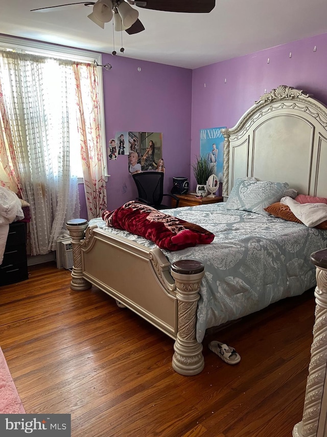 bedroom with ceiling fan and dark wood-type flooring