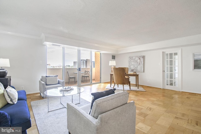 living room featuring ornamental molding, a textured ceiling, and light parquet floors