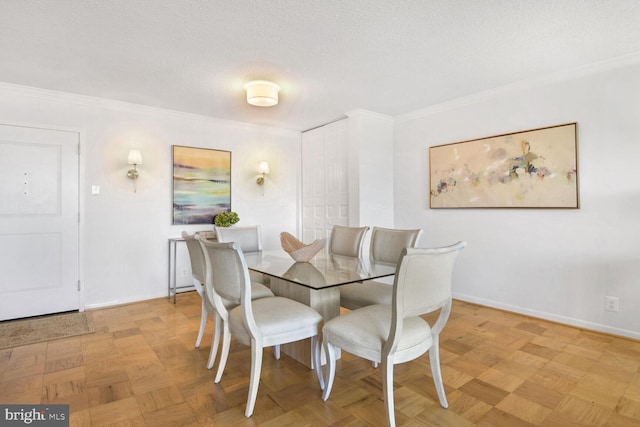 dining room featuring light parquet floors, crown molding, and a textured ceiling