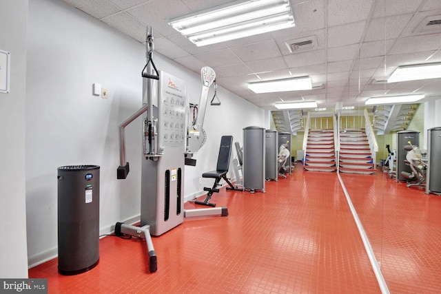 exercise room featuring a drop ceiling