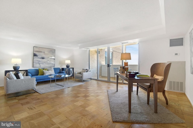 home office featuring light parquet flooring and a textured ceiling