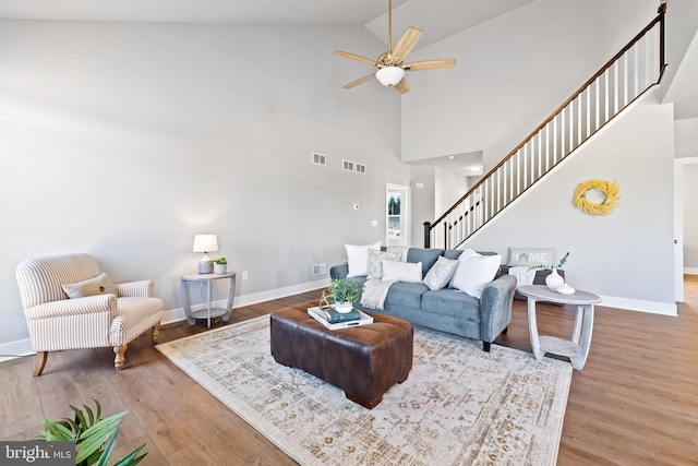 living room with vaulted ceiling, hardwood / wood-style floors, and ceiling fan