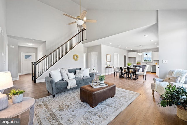 living room with ceiling fan, high vaulted ceiling, and hardwood / wood-style floors