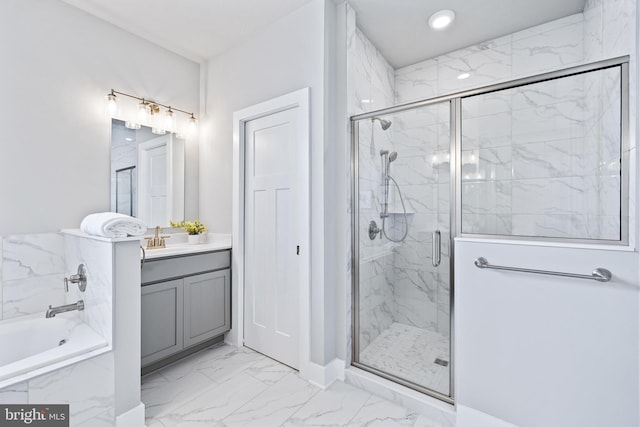 bathroom with vanity and shower with separate bathtub