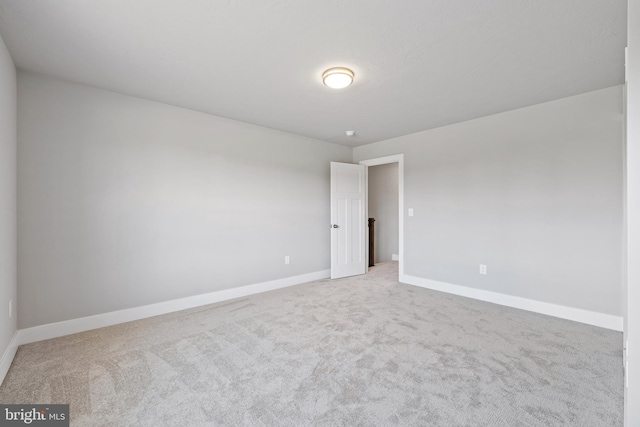 spare room with light colored carpet