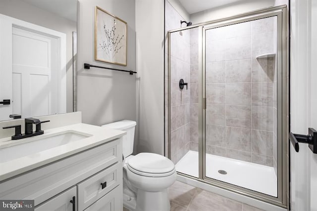 bathroom with vanity, toilet, and an enclosed shower