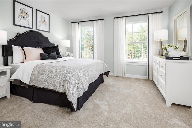 bedroom featuring light carpet