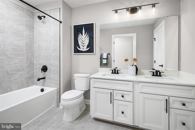 full bathroom with tile patterned floors, vanity, toilet, and tiled shower / bath