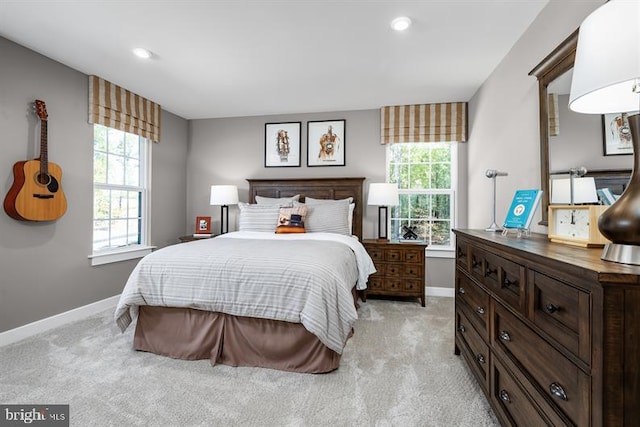 carpeted bedroom featuring multiple windows