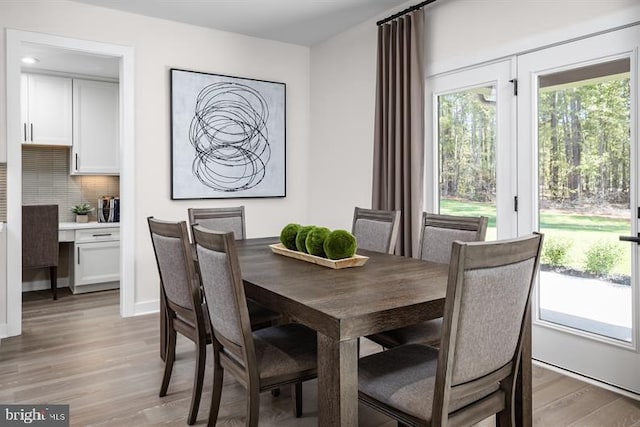 dining space with light hardwood / wood-style floors