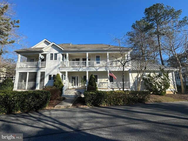 view of front of property with a balcony and covered porch