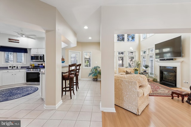 tiled living room featuring ceiling fan