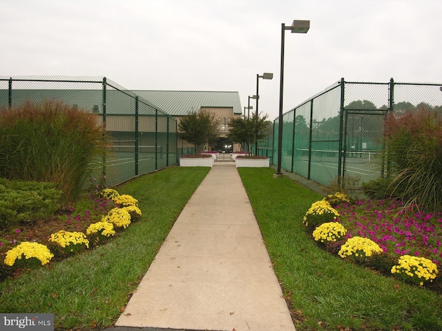 39281 Piney Dr Unit 55115, Bethany Beach, DE 19930 - surrounding community with a lawn, a tennis court, and fence