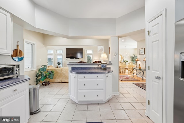 kitchen featuring white cabinets and light tile patterned floors