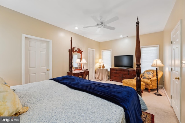 bedroom featuring ceiling fan and light carpet