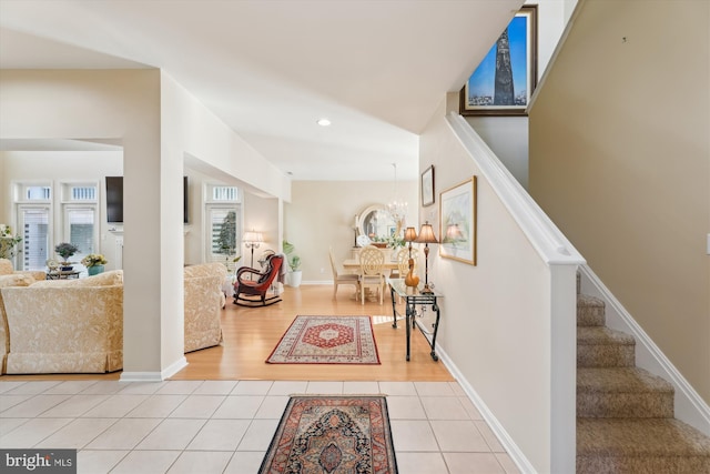 interior space featuring an inviting chandelier and light tile patterned floors