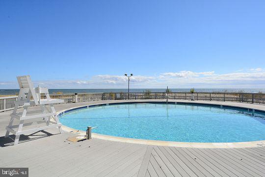 39281 Piney Dr Unit 55115, Bethany Beach, DE 19930 - pool with fence and a wooden deck