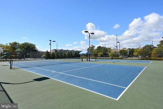 39281 Piney Dr Unit 55115, Bethany Beach, DE 19930 - view of tennis court with community basketball court and fence