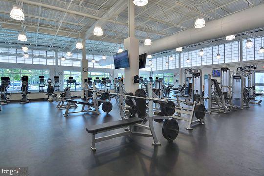 39281 Piney Dr Unit 55115, Bethany Beach, DE 19930 - exercise room featuring a towering ceiling