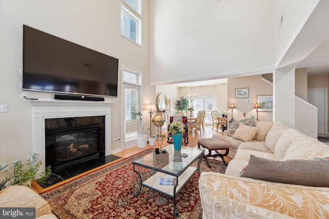 living room with a high ceiling and a chandelier