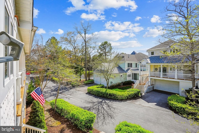 39281 Piney Dr Unit 55115, Bethany Beach, DE 19930 - exterior space featuring an attached garage, driveway, a residential view, and stairs