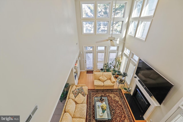 living room featuring a high ceiling and ceiling fan