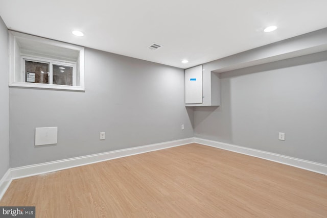 basement with light hardwood / wood-style floors