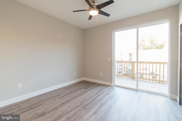 spare room with ceiling fan and light wood-type flooring