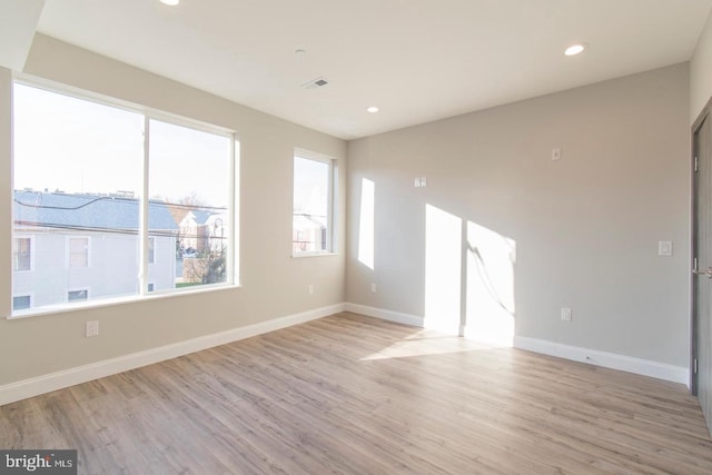 spare room featuring light hardwood / wood-style floors