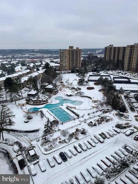 snowy aerial view featuring a city view