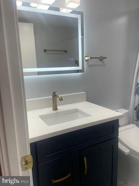 full bathroom with vanity and toilet