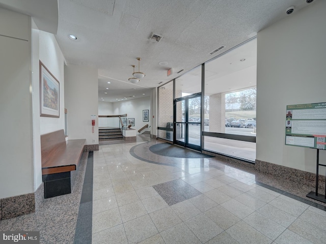 building lobby with stairway and visible vents