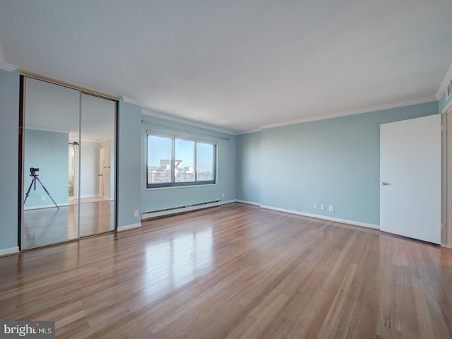 unfurnished bedroom with light wood finished floors, a baseboard radiator, and crown molding