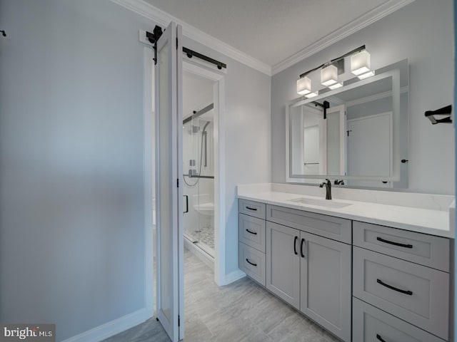 bathroom with baseboards, a shower stall, vanity, and crown molding