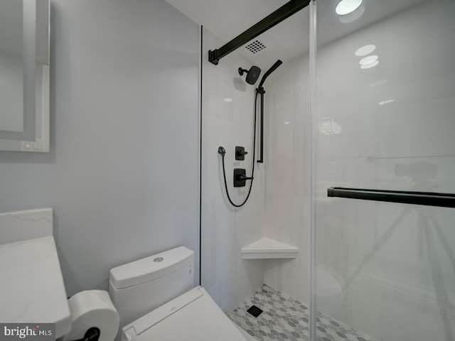 full bath featuring a stall shower and toilet