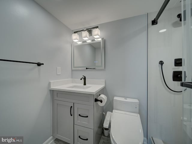 bathroom with toilet, a tile shower, and vanity