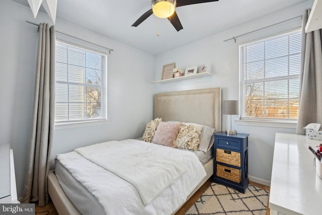 bedroom with ceiling fan and multiple windows