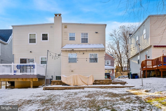 snow covered property featuring a deck and central air condition unit