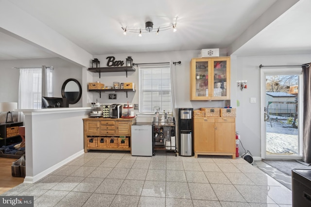 kitchen featuring a healthy amount of sunlight and fridge