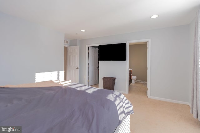 carpeted bedroom featuring ensuite bathroom