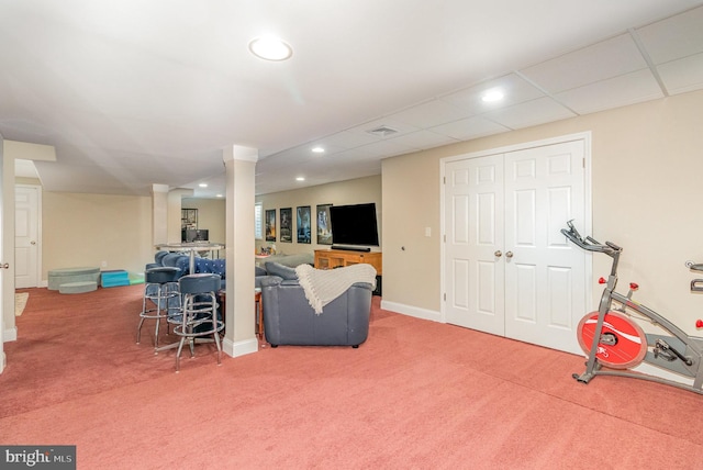 interior space with carpet floors and a drop ceiling