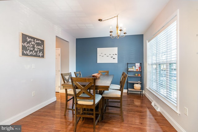 dining space featuring a chandelier, dark hardwood / wood-style flooring, and plenty of natural light