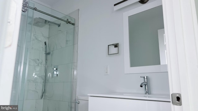 bathroom featuring vanity, toilet, and walk in shower