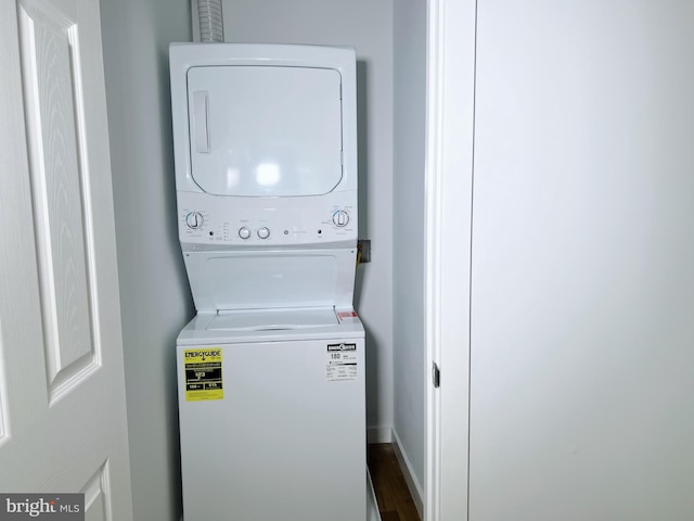 laundry room featuring stacked washer / drying machine