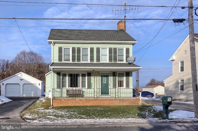 front facade featuring a garage, a porch, and an outdoor structure