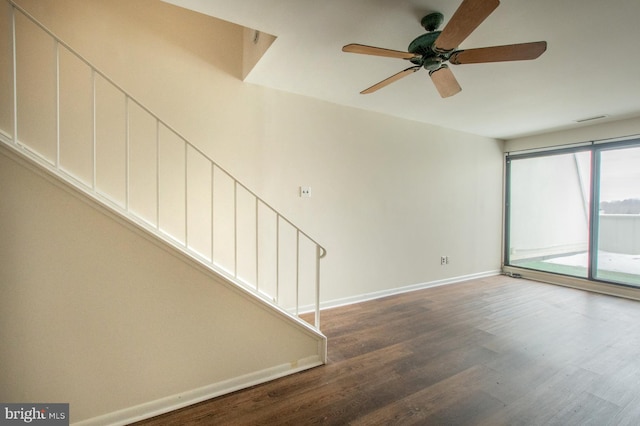 spare room with ceiling fan and dark wood-type flooring