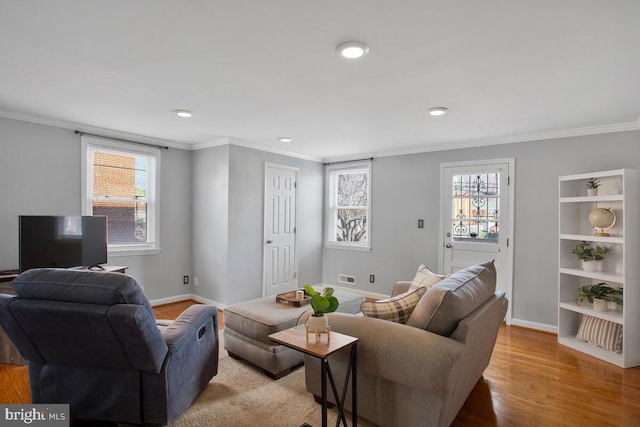 living room with light hardwood / wood-style floors and ornamental molding