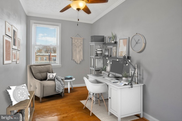 home office with ceiling fan, light hardwood / wood-style floors, ornamental molding, and a textured ceiling