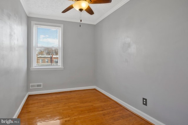 spare room with a textured ceiling, light hardwood / wood-style flooring, ceiling fan, and crown molding