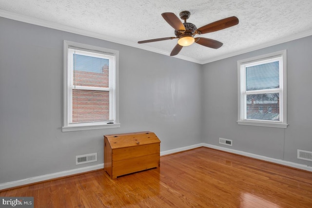 empty room with light hardwood / wood-style flooring and a healthy amount of sunlight